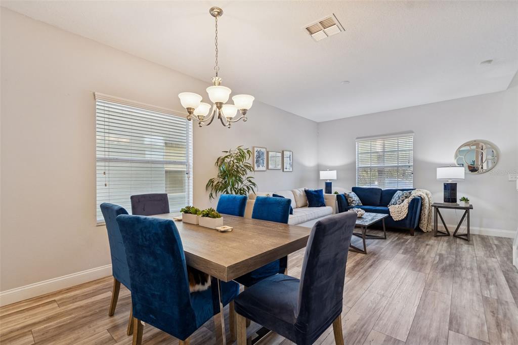 3620 Lefays Point Land O Lakes, FL 34638 - Photo 3 of 50 a view of a dining room with furniture wooden floor and chandelier