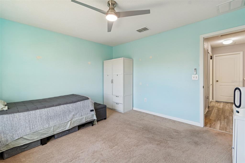3620 Lefays Point Land O Lakes, FL 34638 - Photo 32 of 50 a room with a bed and a dresser