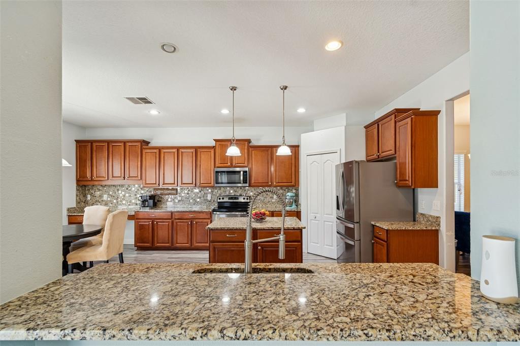3620 Lefays Point Land O Lakes, FL 34638 - Photo 10 of 50 a kitchen with stainless steel appliances granite countertop a stove refrigerator and cabinets