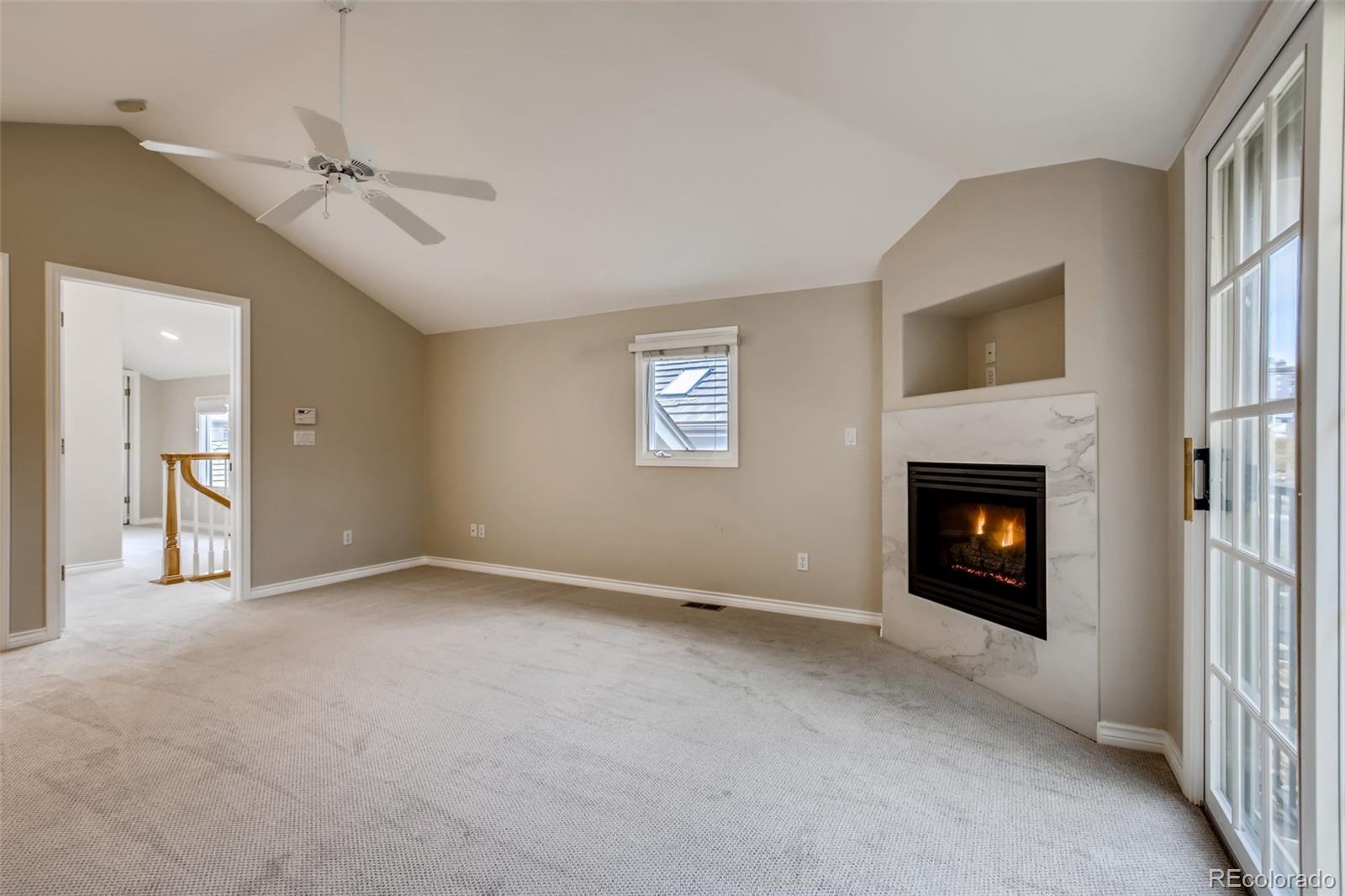 210 Cook Street Denver, CO 80206 - Photo 18 of 34 a view of an empty room with a fireplace and a window
