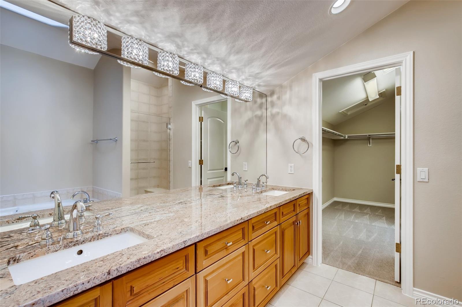 210 Cook Street Denver, CO 80206 - Photo 19 of 34 a bathroom with a granite countertop sink mirror and double