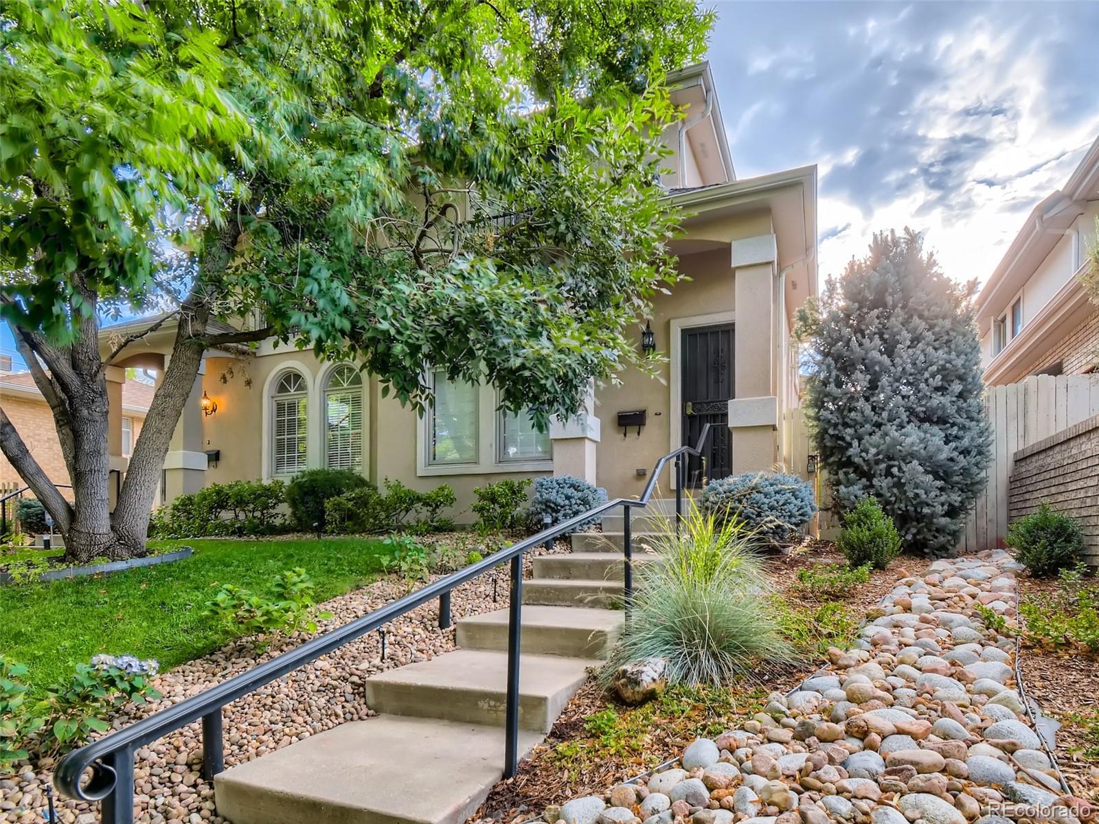210 Cook Street Denver, CO 80206 - Photo 2 of 34 a front view of a house with a yard