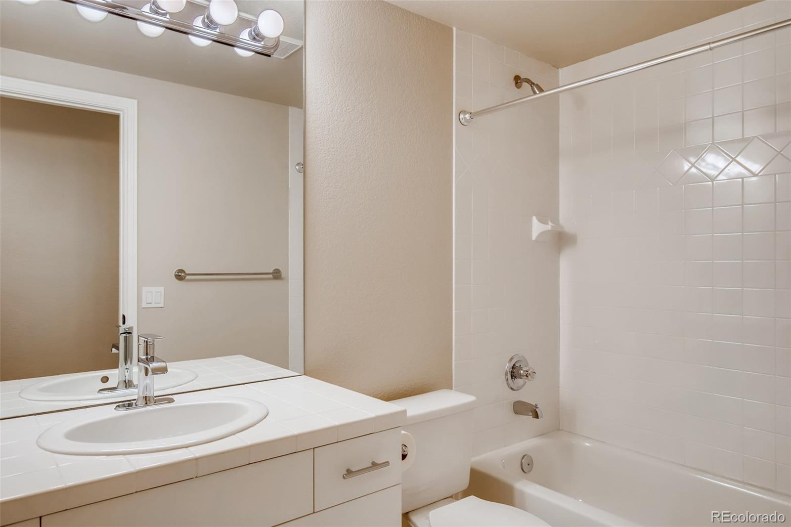210 Cook Street Denver, CO 80206 - Photo 25 of 34 a bathroom with a sink double vanity granite tub shower and a mirror