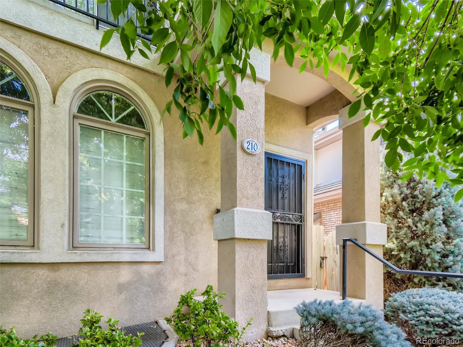 210 Cook Street Denver, CO 80206 - Photo 3 of 34 a front view of a house with garden