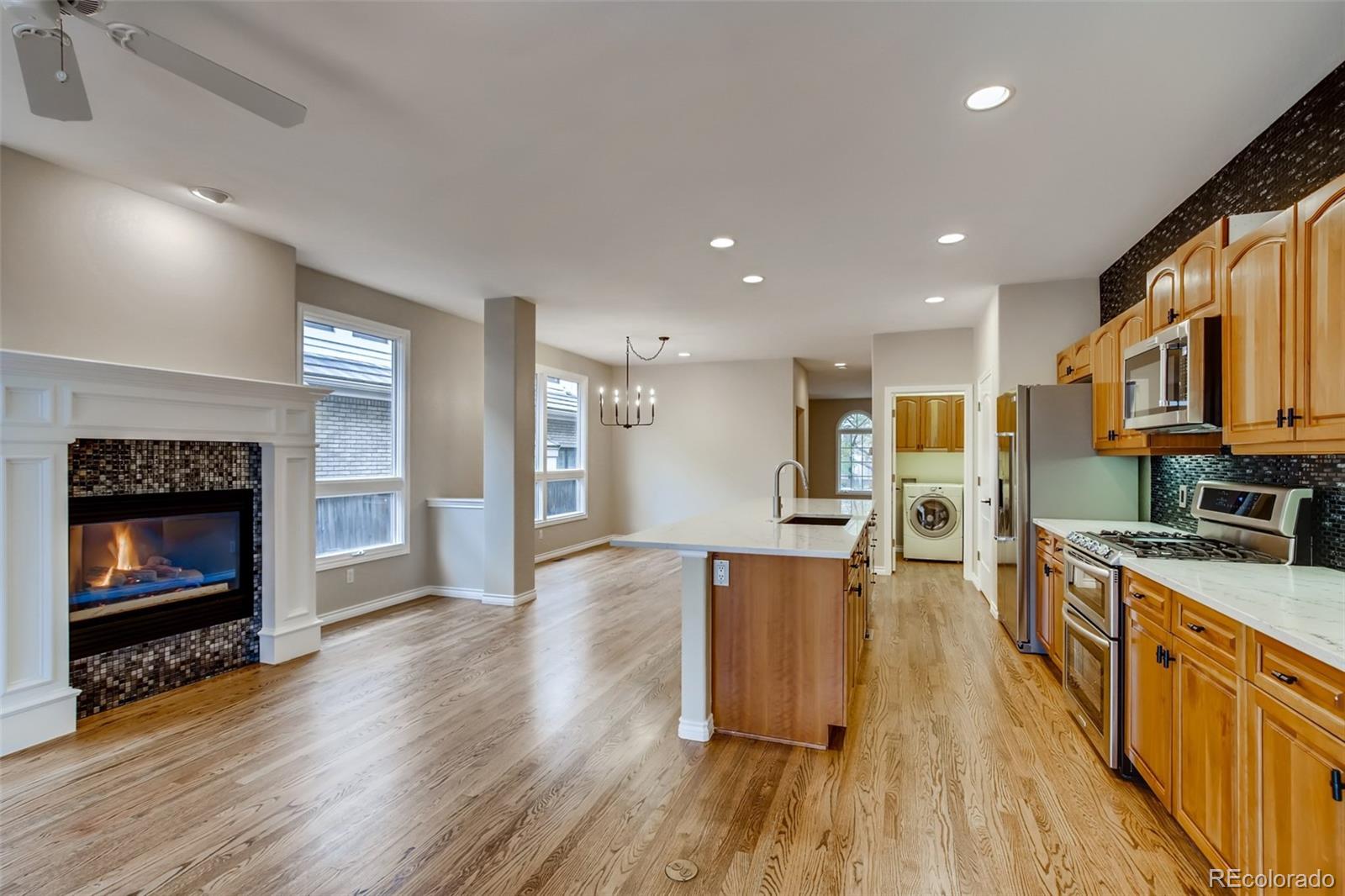 210 Cook Street Denver, CO 80206 - Photo 7 of 34 a large kitchen with stainless steel appliances granite countertop a stove a sink dishwasher and a oven with wooden floor