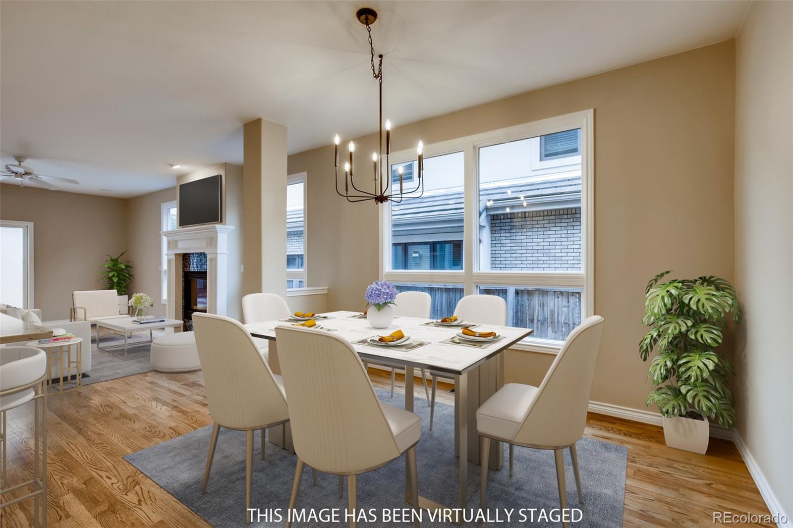 210 Cook Street Denver, CO 80206 - Photo 8 of 34 a dining room with furniture a chandelier and wooden floor