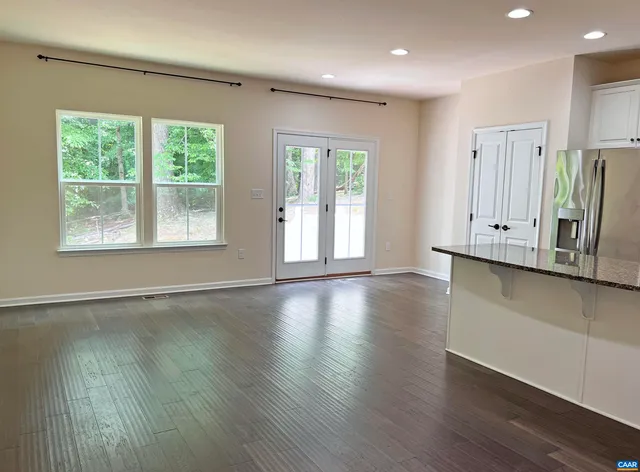 a bathroom with a granite countertop toilet and a shower