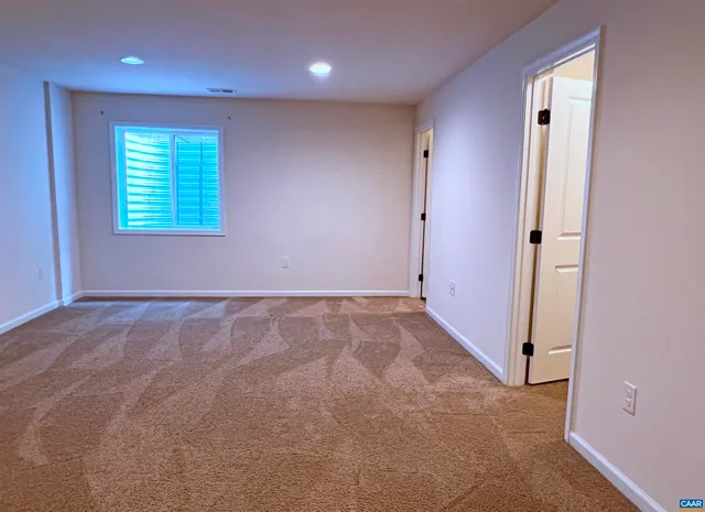 a bathroom with a granite countertop sink mirror vanity and toilet
