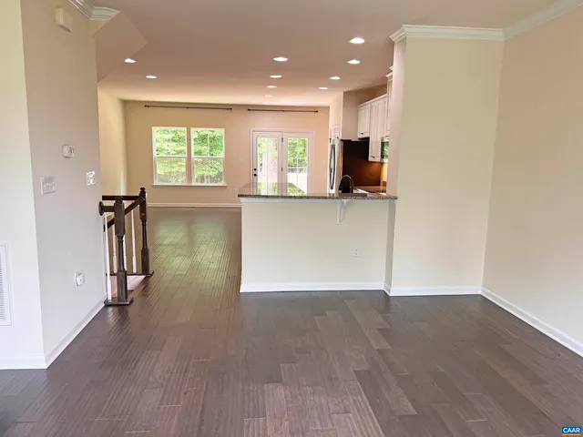 an empty room with wooden floor and a window