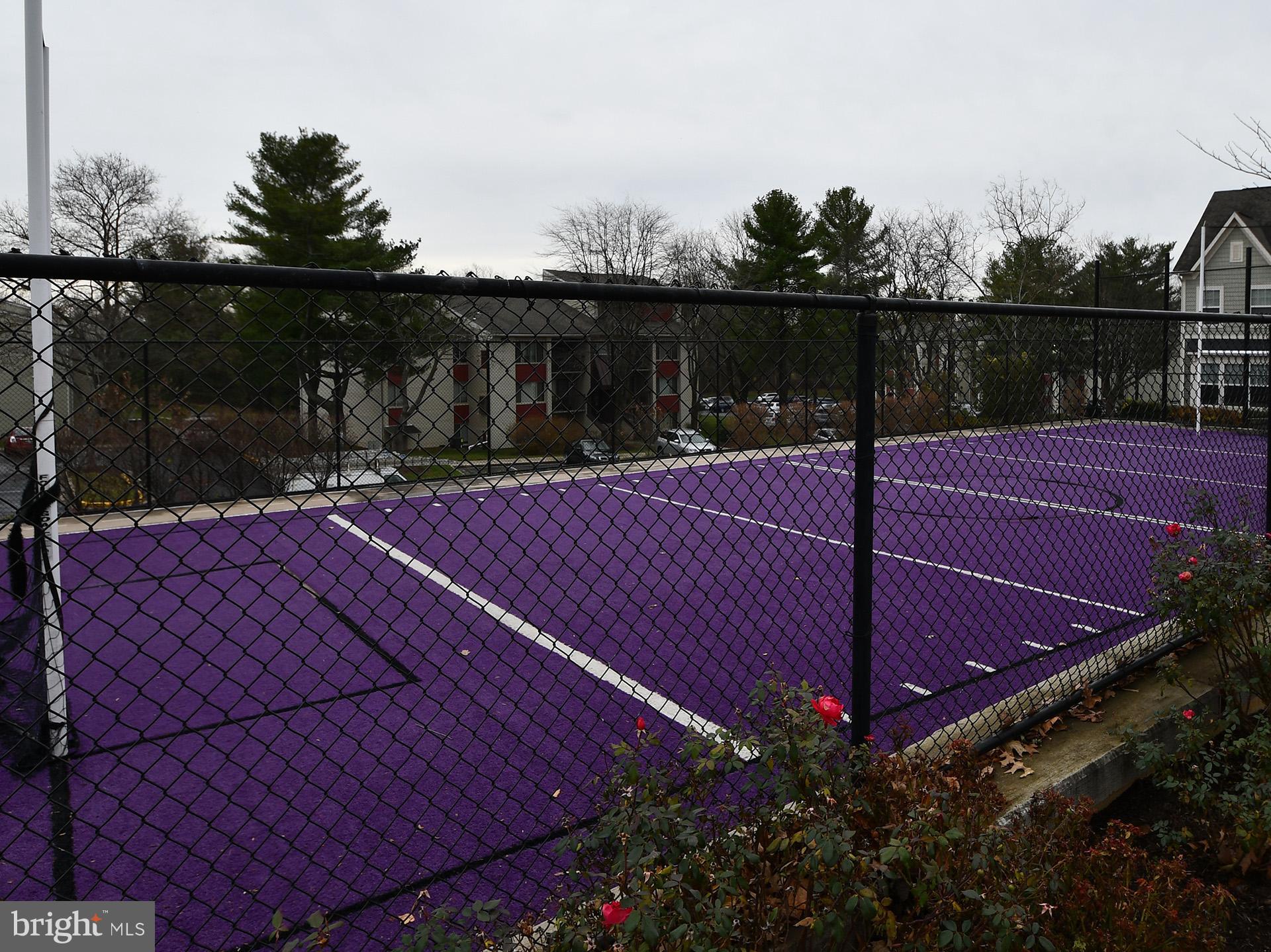 3511 Castle Way, Unit 312 Silver Spring, MD 20904 - Photo 19 of 20 a view of a tennis ground with large trees