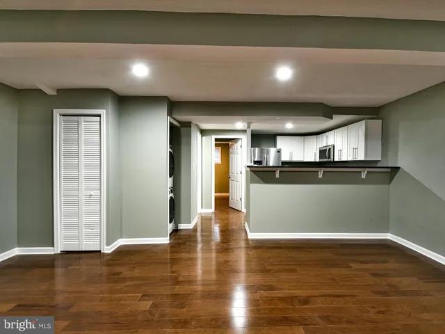 a view of kitchen with refrigerator and window