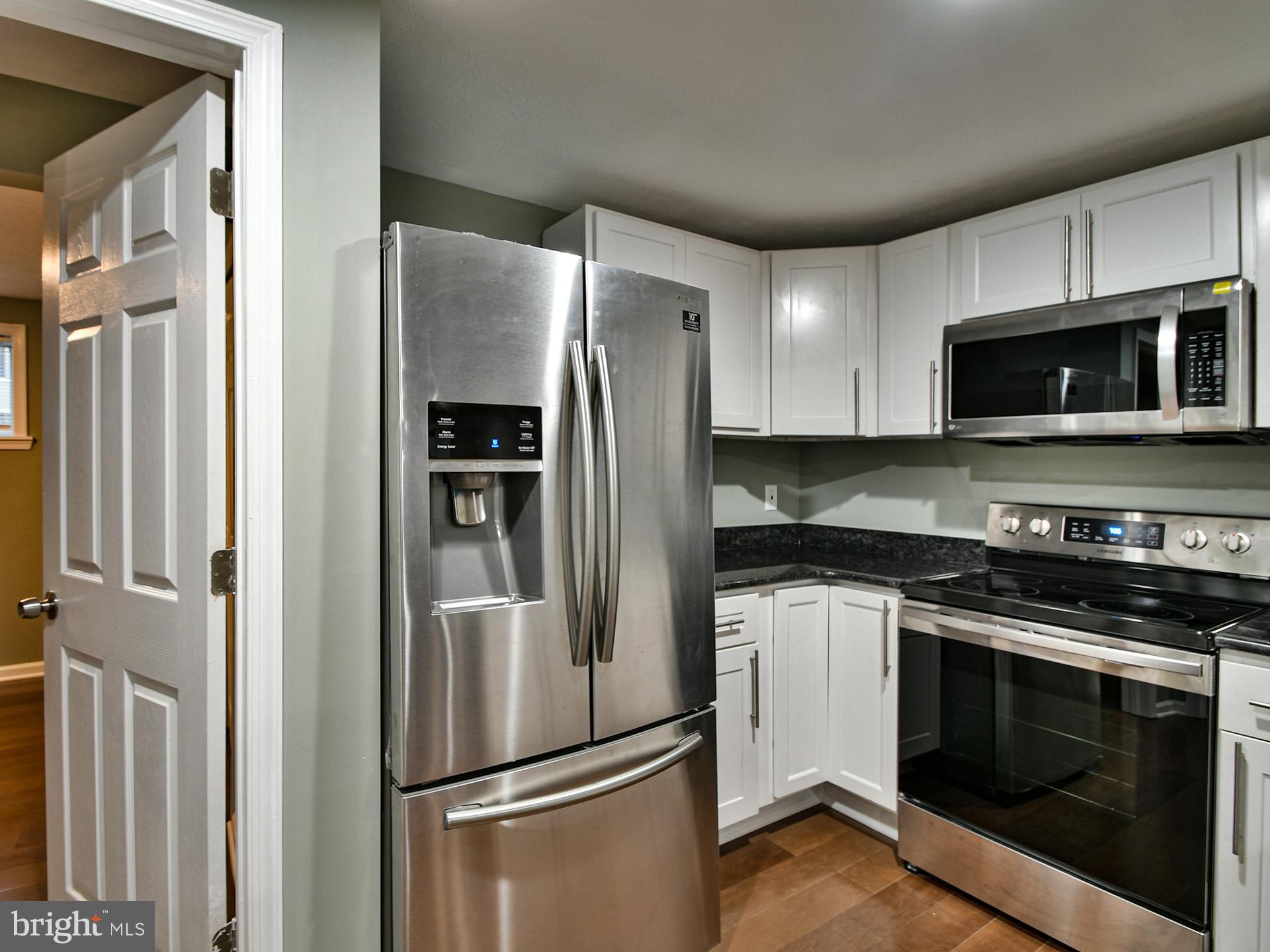 3511 Castle Way, Unit 312 Silver Spring, MD 20904 - Photo 6 of 20 a metallic refrigerator freezer sitting in a kitchen