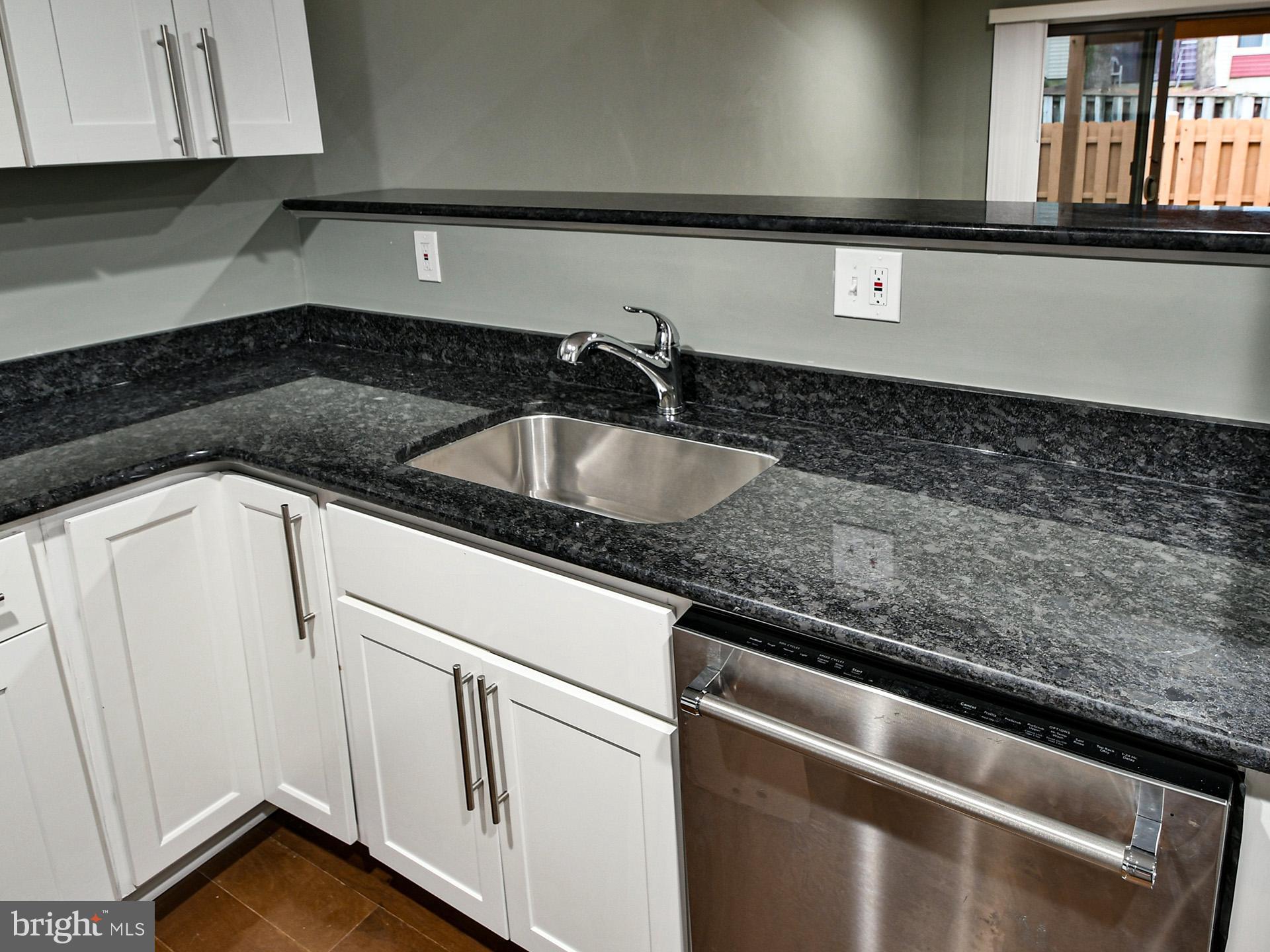 3511 Castle Way, Unit 312 Silver Spring, MD 20904 - Photo 7 of 20 a close view of a sink and dishwasher in a kitchen