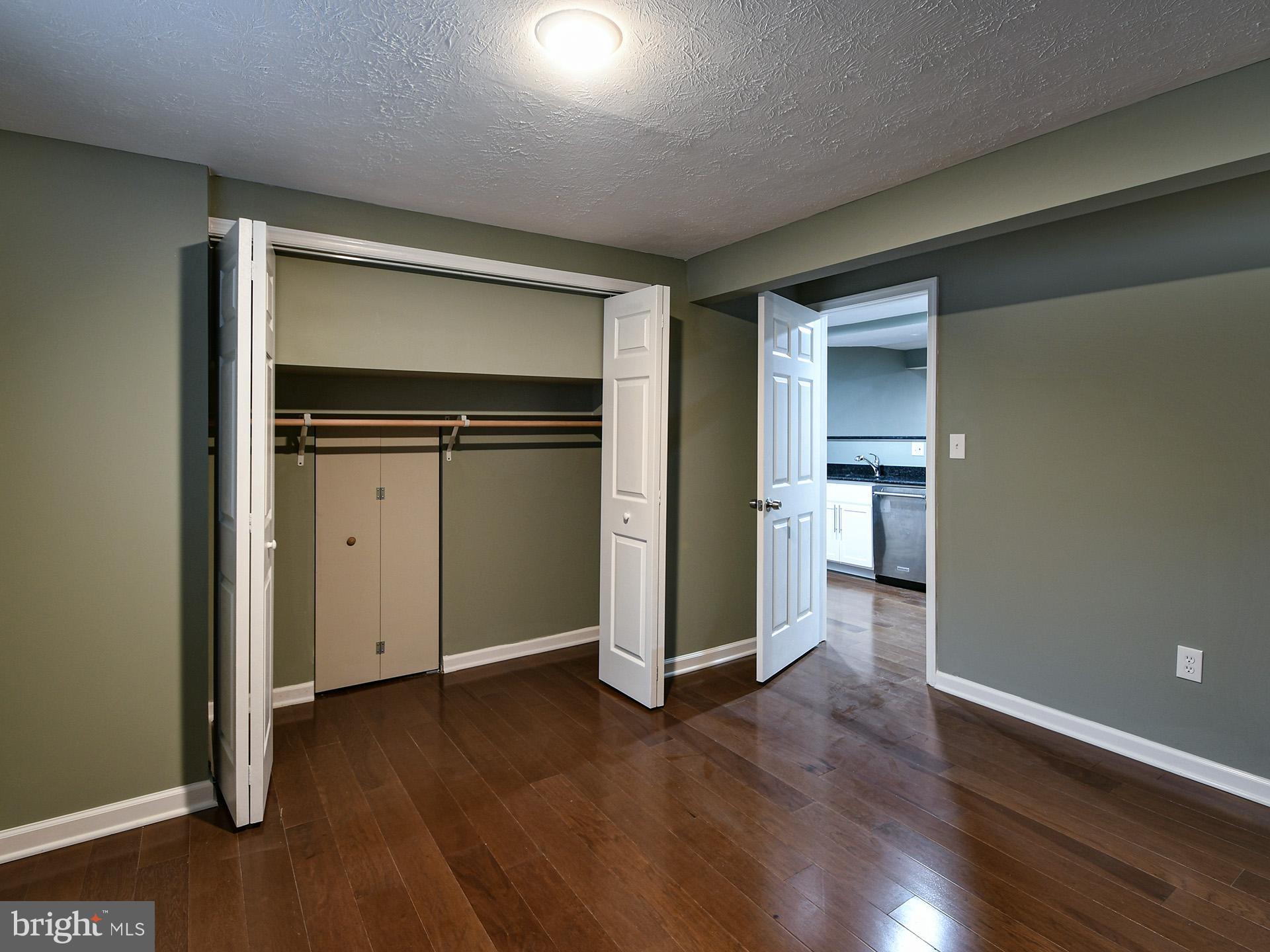 3511 Castle Way, Unit 312 Silver Spring, MD 20904 - Photo 10 of 20 an empty room with wooden floor closet and windows