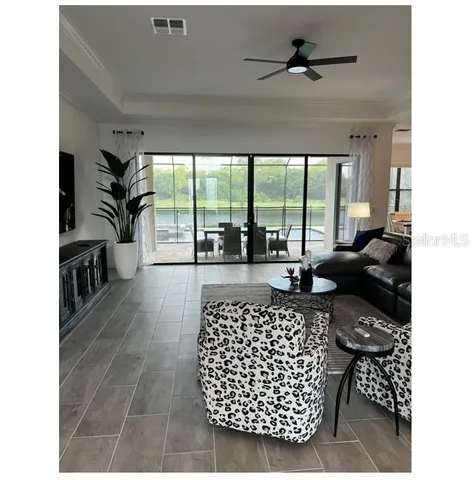 a living room with furniture floor to ceiling window and a floor to ceiling window