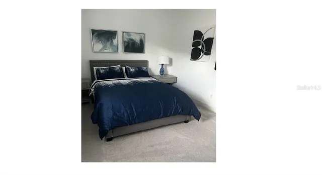 a bedroom with a bed and wall painting