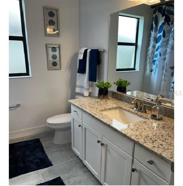 17021 Polo Trail Lakewood Ranch, FL 34211 - Photo 31 of 42 a bathroom with a granite countertop sink and a mirror