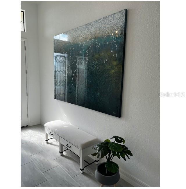 17021 Polo Trail Lakewood Ranch, FL 34211 - Photo 5 of 42 a room with a couch and a potted plant