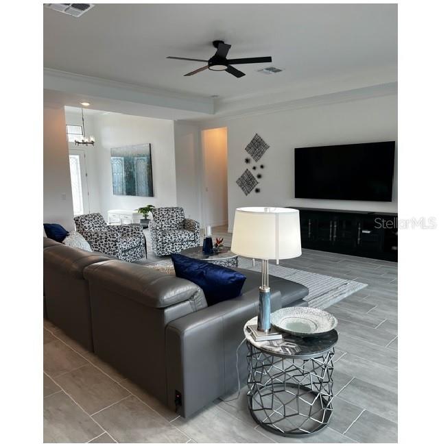 17021 Polo Trail Lakewood Ranch, FL 34211 - Photo 9 of 42 a living room with furniture and a flat screen tv