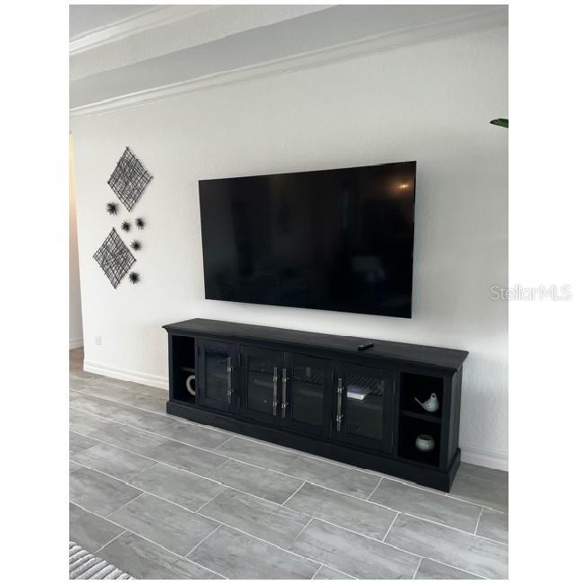 17021 Polo Trail Lakewood Ranch, FL 34211 - Photo 10 of 42 a living room with stainless steel appliances kitchen island granite countertop a fireplace and a flat screen tv