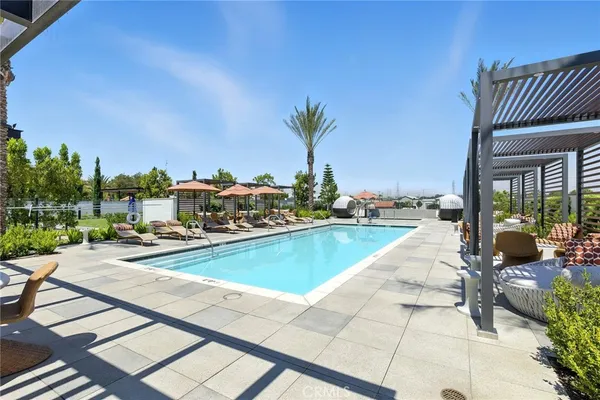 a view of swimming pool with outdoor seating and a terrace