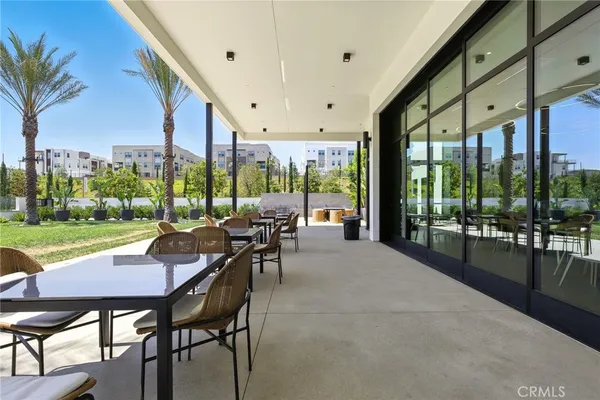 a view of a patio with a dining table and chairs