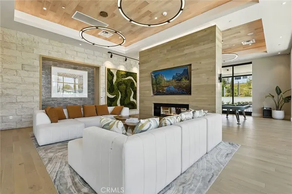 a living room with furniture a large window and a flat screen tv