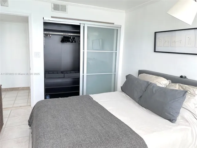 a bedroom with a bed and a cabinet