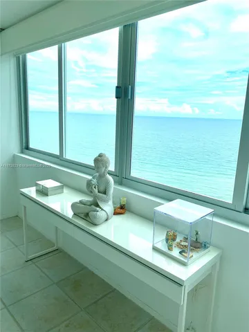 a bathroom with a sink mirror and a window