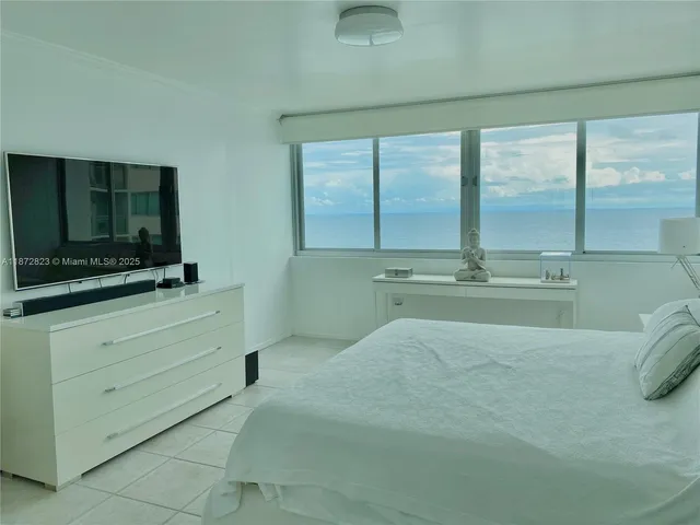 a room with a bed and a flat screen tv