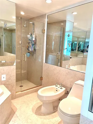 a bathroom with a toilet sink and shower