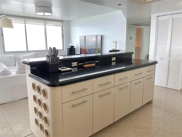 a kitchen with white cabinets and a sink
