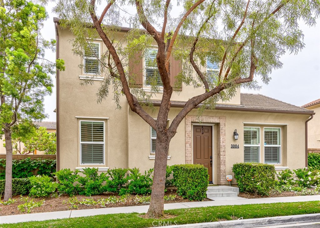 a front view of a house with yard and green space
