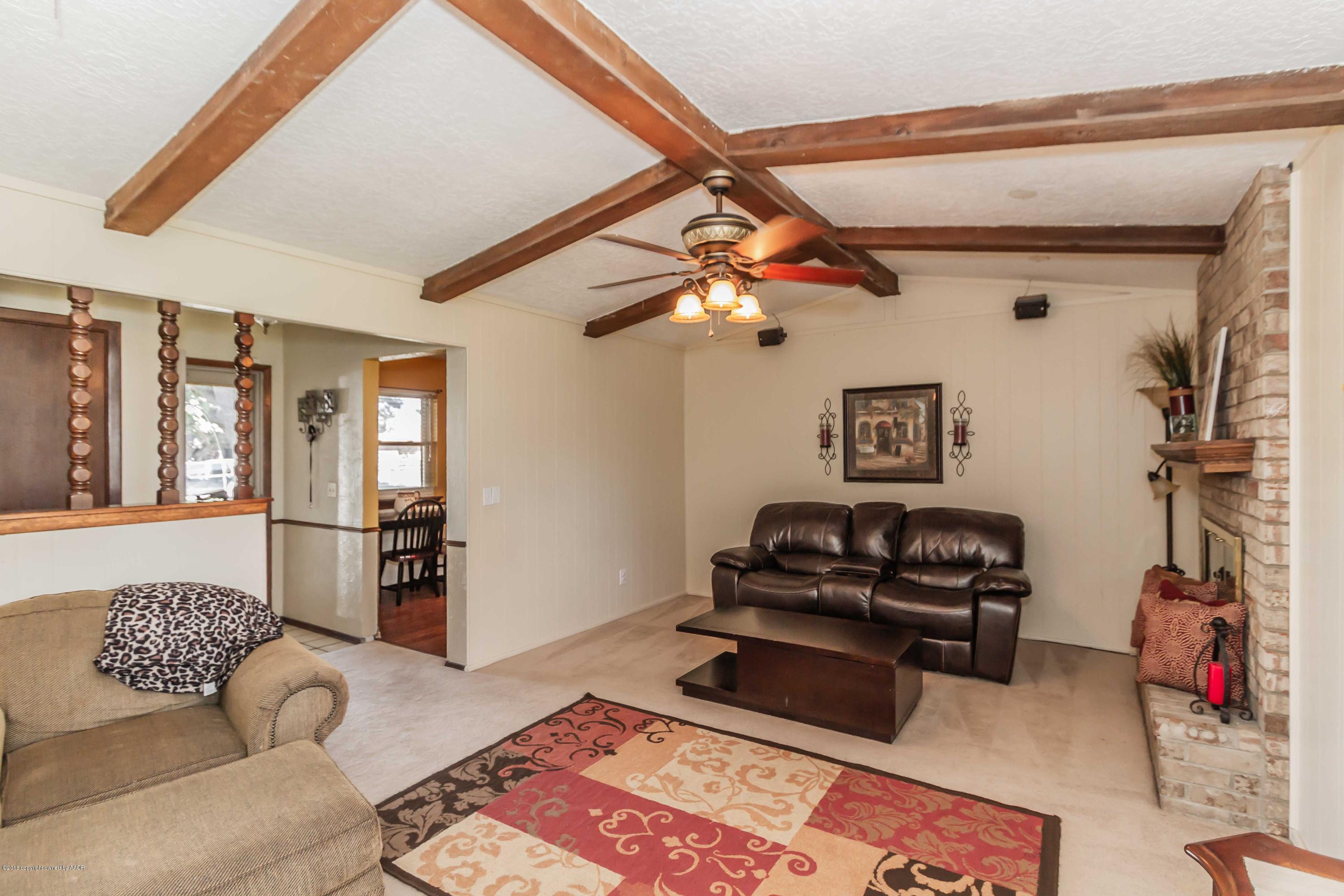 5205 South Milam Street Amarillo, TX 79110 - Photo 2 of 23 a living room with furniture and a flat screen tv