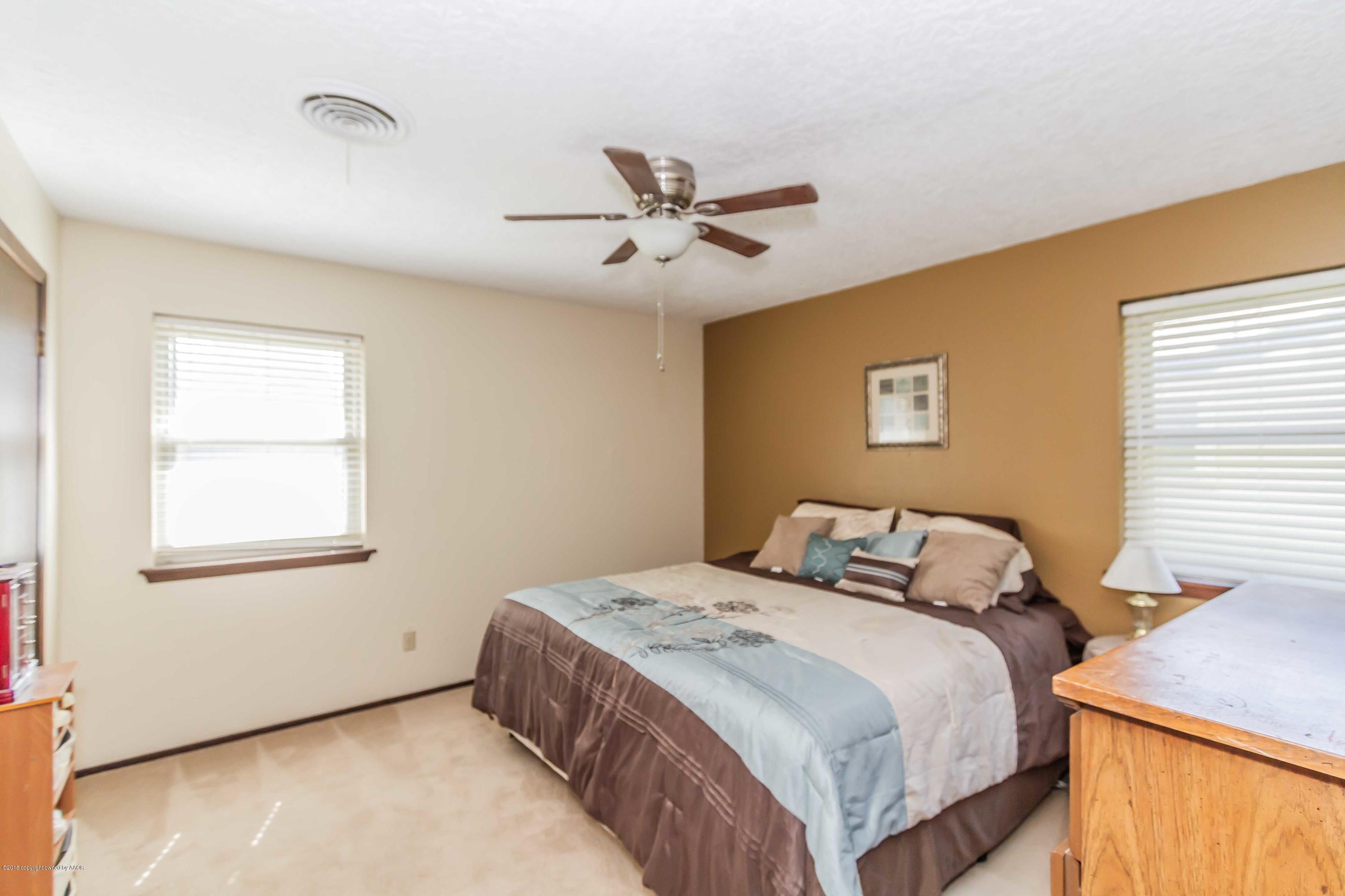 5205 South Milam Street Amarillo, TX 79110 - Photo 11 of 23 a bedroom with a bed and a window