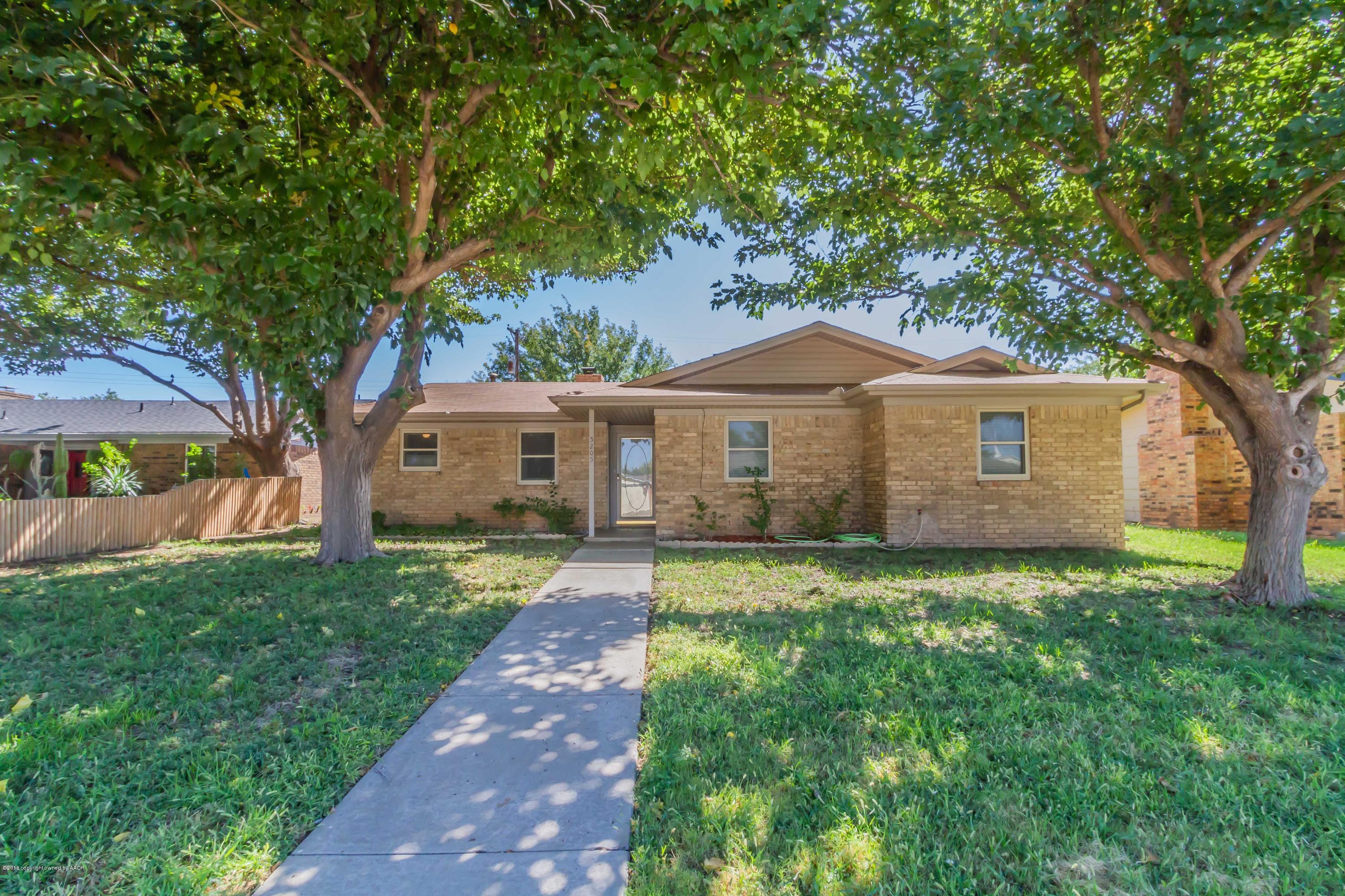 5205 South Milam Street Amarillo, TX 79110 - Photo 13 of 23 a front view of a house with garden