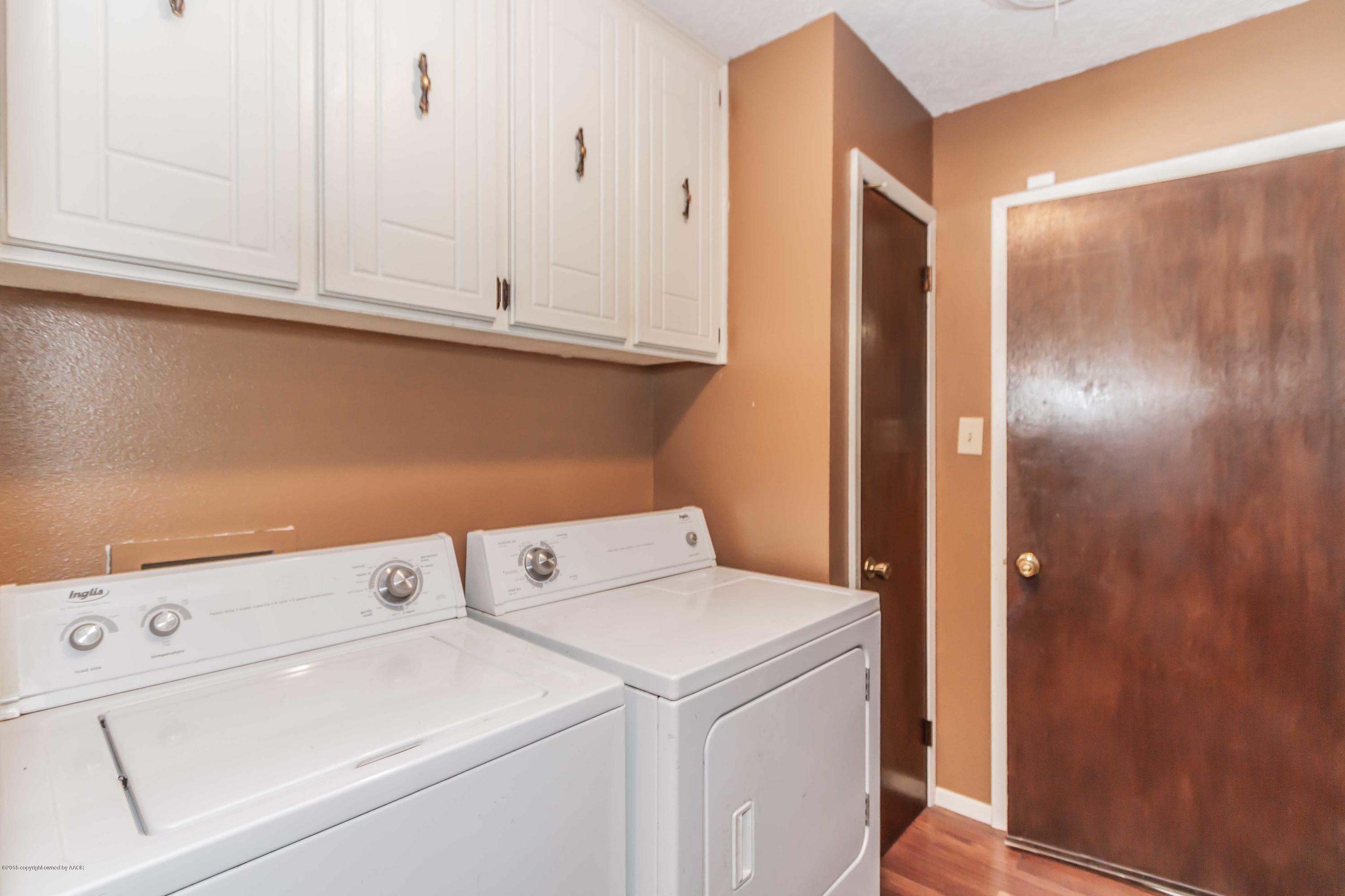 5205 South Milam Street Amarillo, TX 79110 - Photo 18 of 23 a view of storage and utility room with washer and dryer