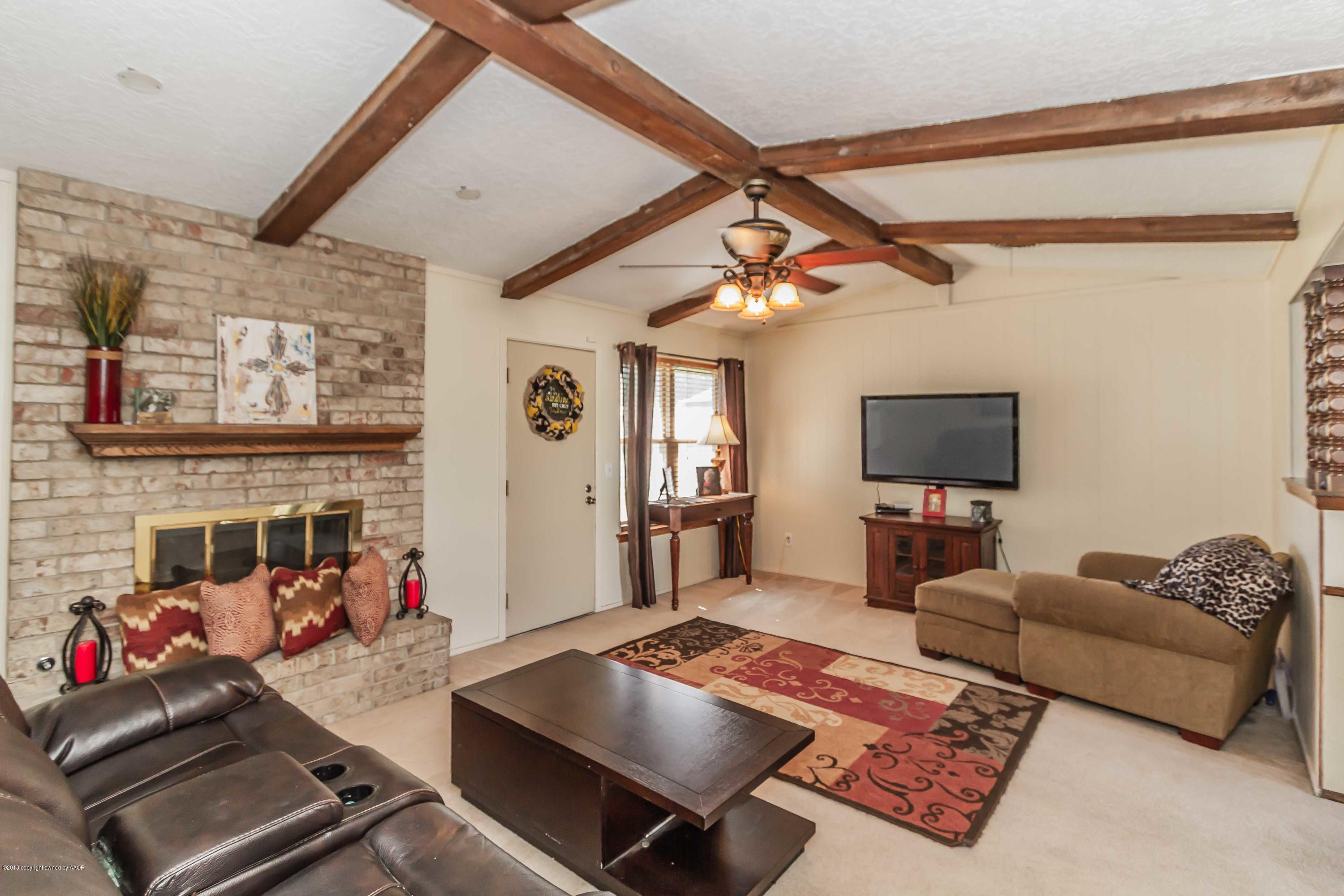 5205 South Milam Street Amarillo, TX 79110 - Photo 3 of 23 a living room with furniture and a flat screen tv