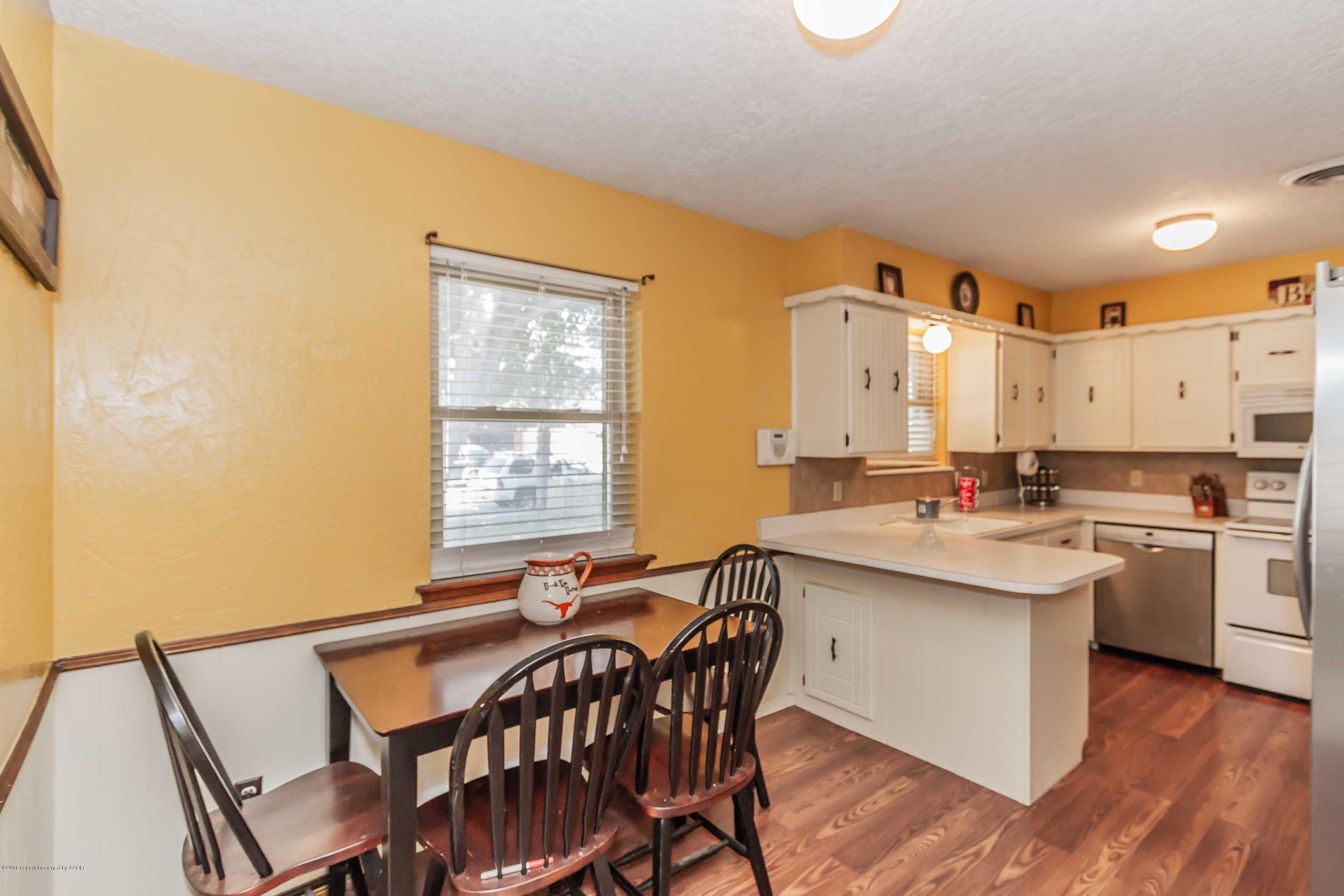 5205 South Milam Street Amarillo, TX 79110 - Photo 9 of 23 a kitchen with a sink and chairs