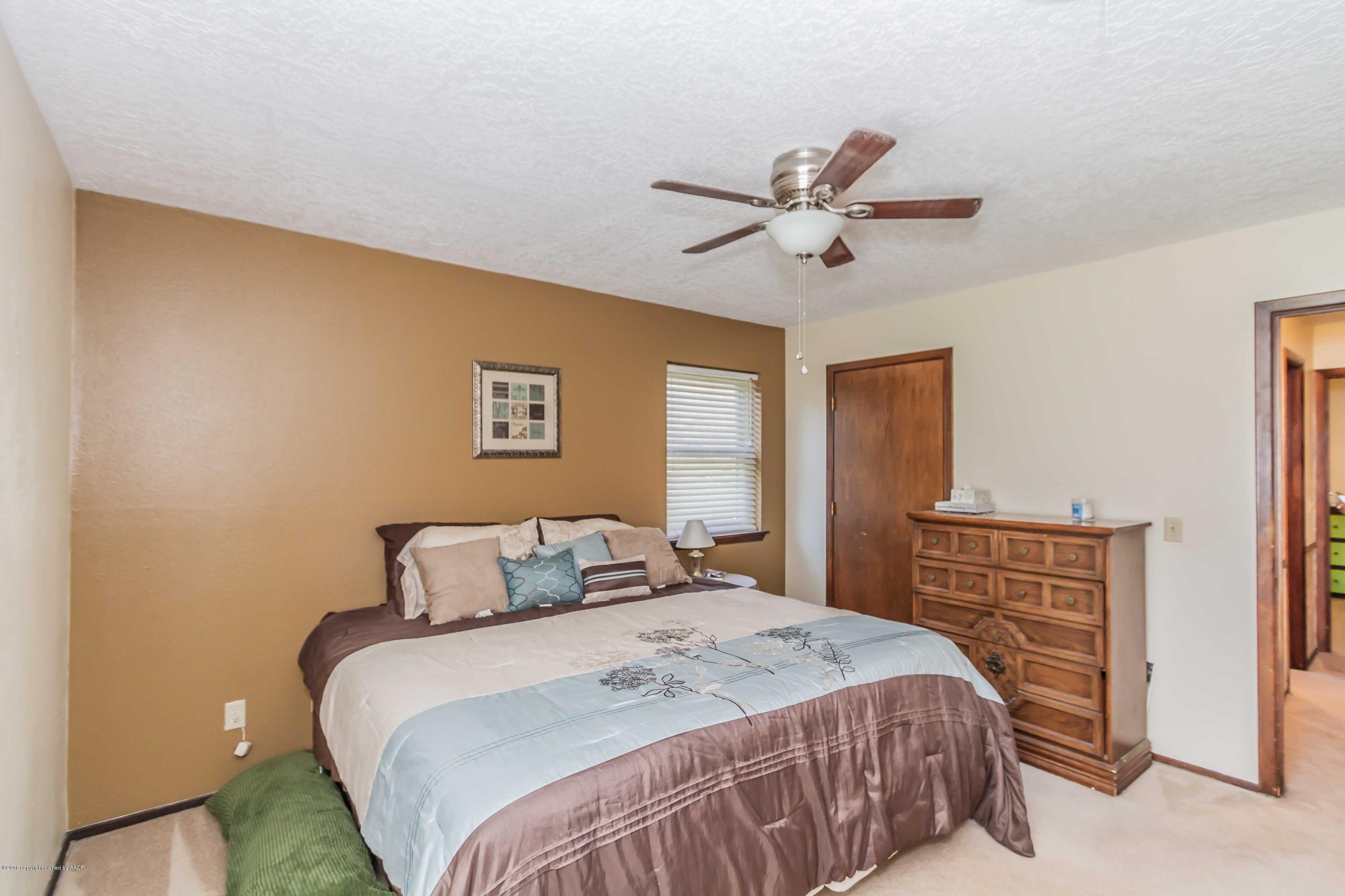 5205 South Milam Street Amarillo, TX 79110 - Photo 10 of 23 a bedroom with a bed and a ceiling fan