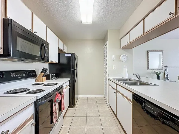 a kitchen with stainless steel appliances a stove sink microwave and cabinets