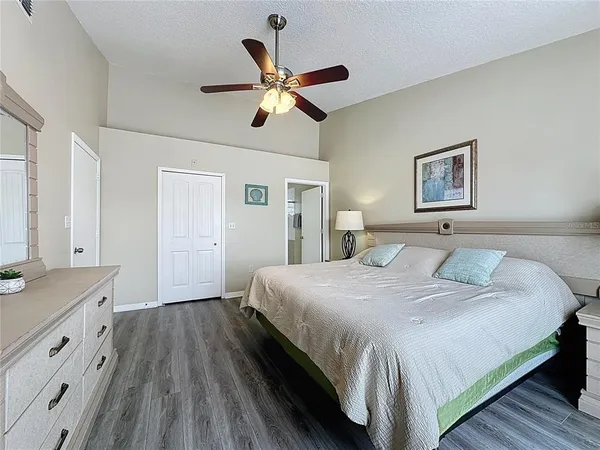 a bedroom with a large bed and a chandelier