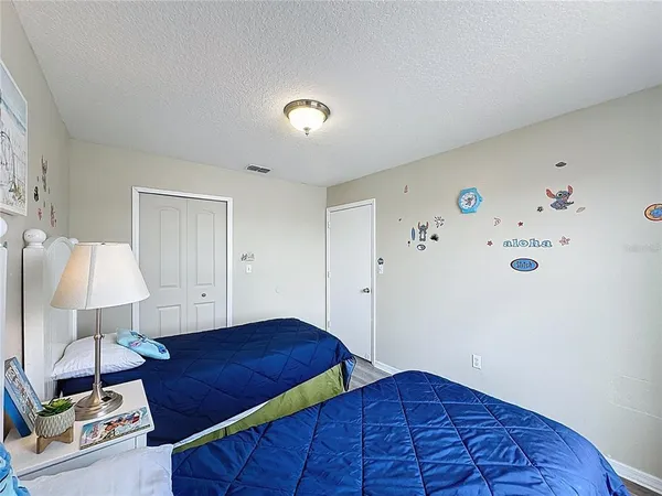 a bedroom with a bed and a lamp