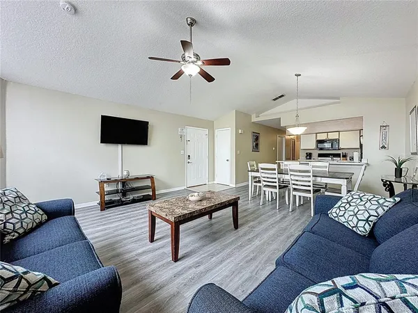 a living room with furniture and wooden floor
