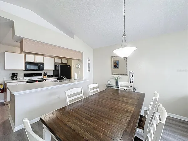 a large kitchen with a table and chairs in it