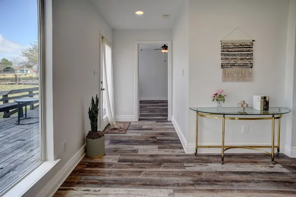 a view of entryway and hall with wooden floor