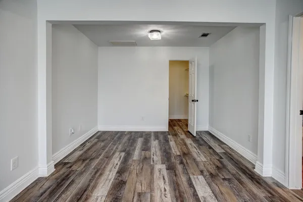 a view of a room with wooden floor