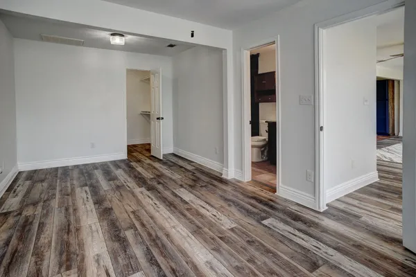 a view of a room with wooden floor and stairs