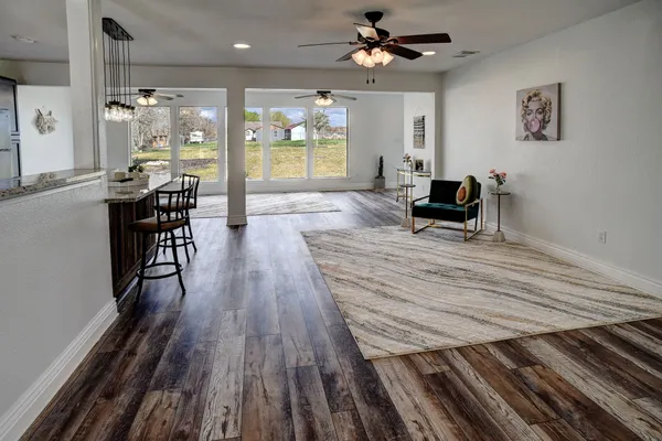 a view of a livingroom with furniture window and wooden floor
