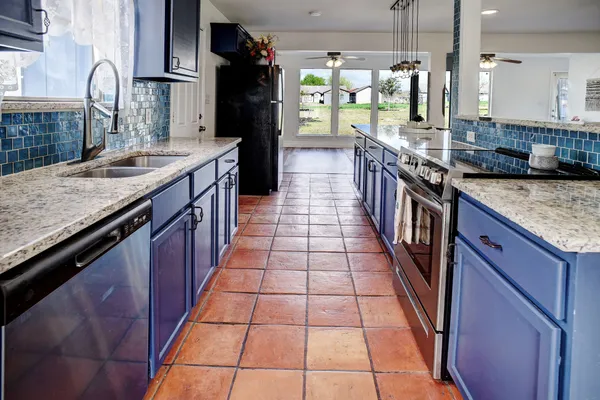 a kitchen with granite countertop lots of counter top space and stainless steel appliances